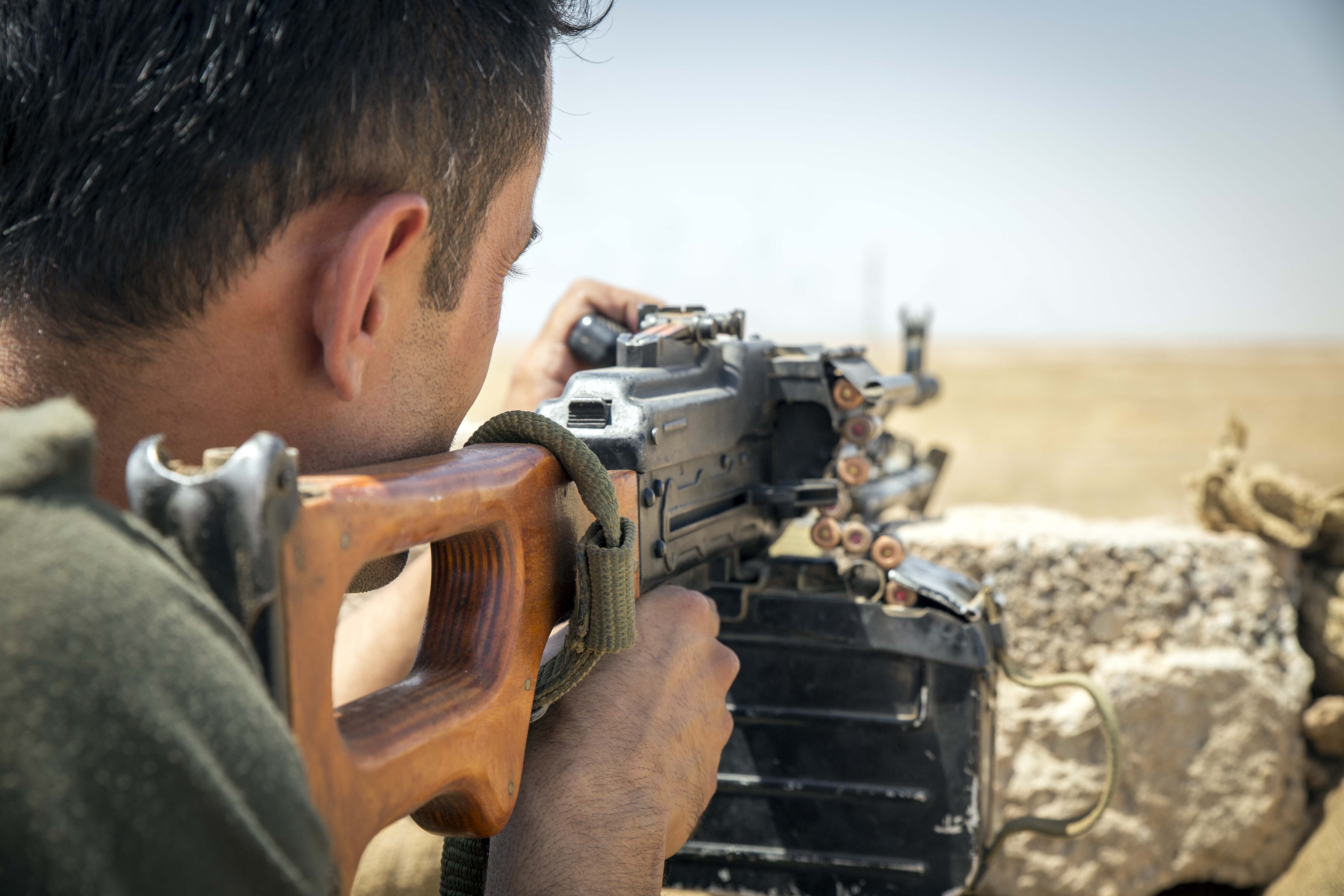 A fighter in position with his Russian made PK machine gun at the frontline south of Kirkuk. 