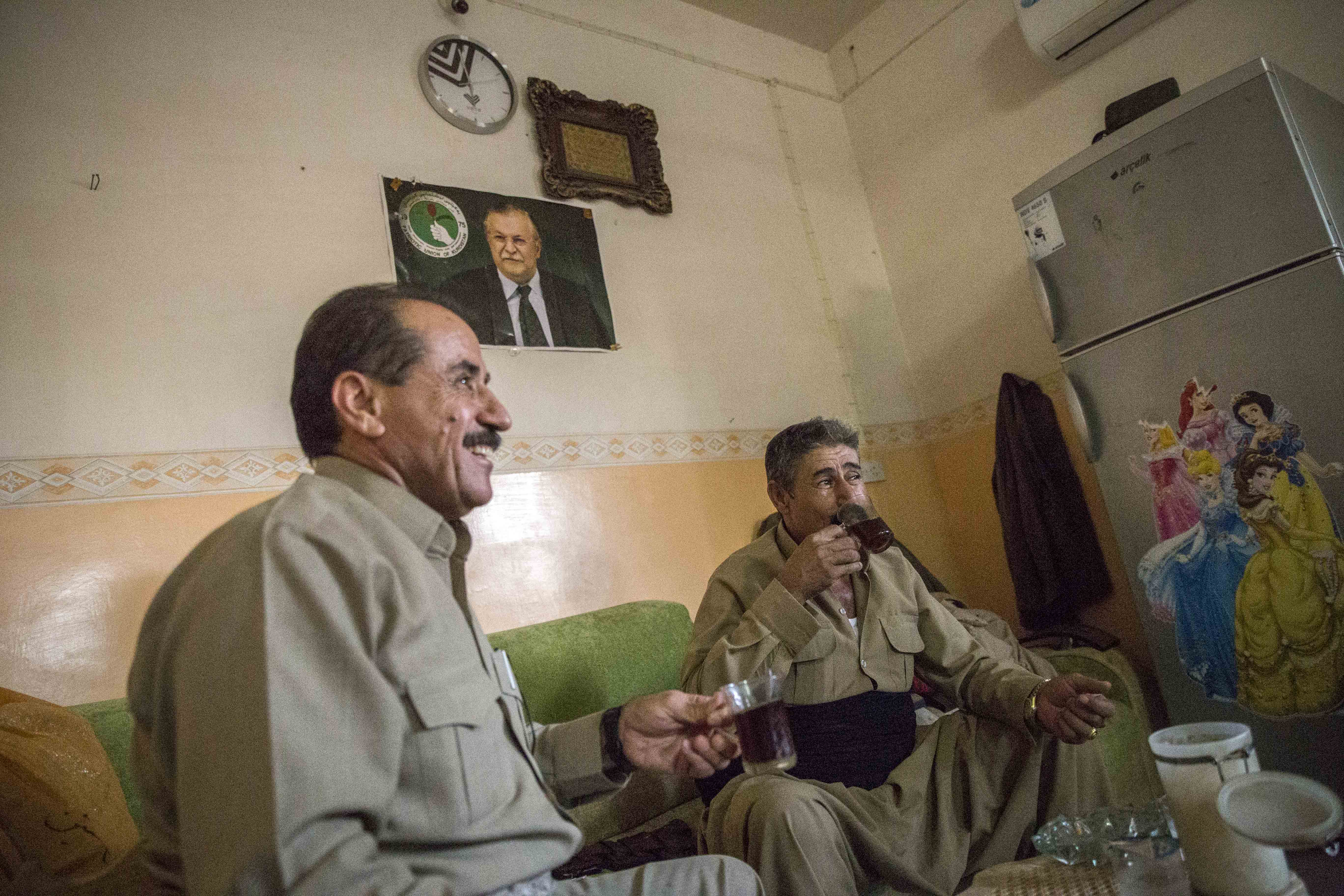 Retired liwa Saleh laughs with his old comrades about the things they did in previous wars, including fighting the forces of Saddam Hussein. 