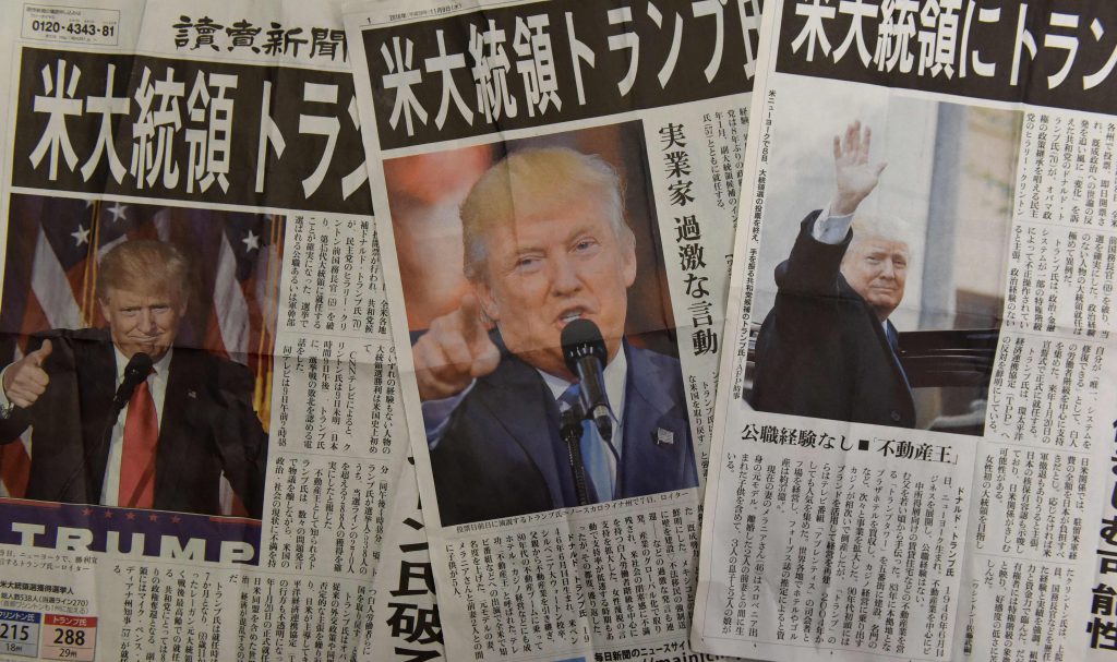 This photo illustration shows extra editions of Japanese newspapers reporting the victory of Donald Trump in the US presidential election in Tokyo on November 9, 2016. AFP PHOTO / TORU YAMANAKA