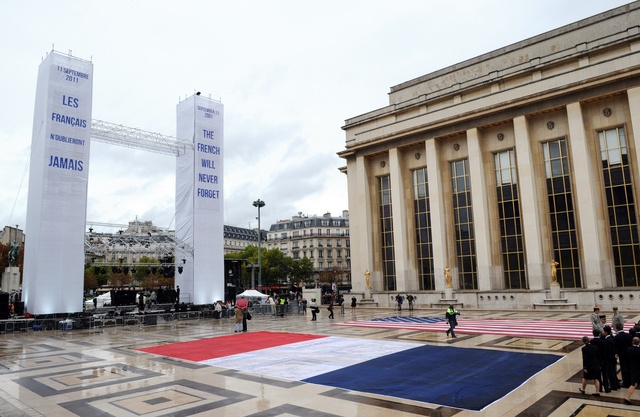 Parisians unfurled American and French flags at a rainy memorial ceremony where two towers read in French and English respectively, "Les Français n'oublieront jamais--The French will never forget." (Getty image)