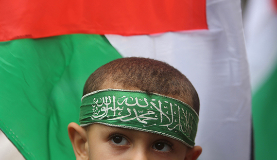 Palestinian boy wears a Hamas headband during an anti-Israel rally, in the central Gaza Strip, Oct. 23, 2015. (photo by REUTERS/Ibraheem Abu Mustafa)